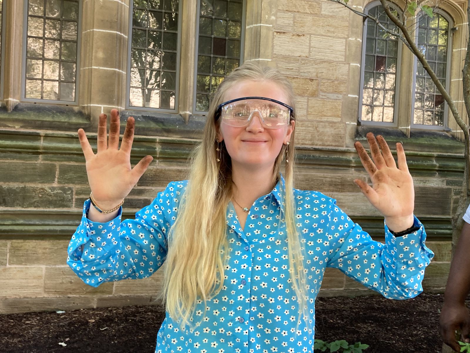 Photo of Yale student with dirt on her hands