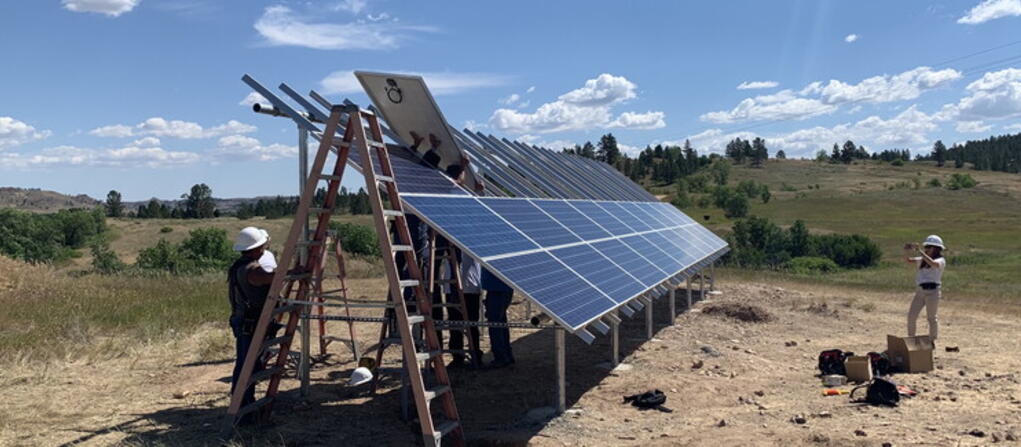 Workers installing a solar power array