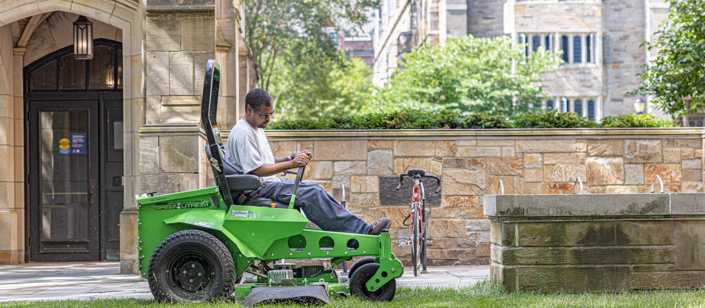 A Yale staff member uses a battery powered, zero-emission mower