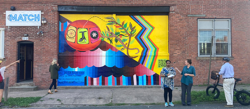 A colorful climate mural on a brick wall made using cooling paint, and sponsored by Yale Planetary Solutions