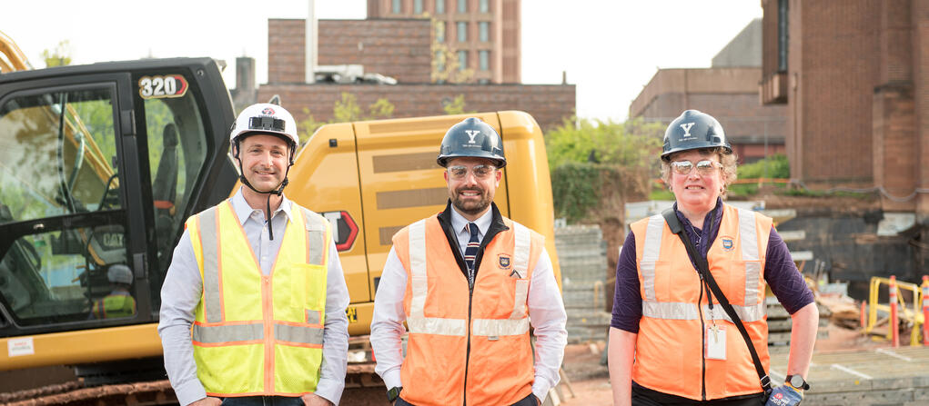 Yale staff and contractors in hard hats on a job site for the Upper Science Hill Development