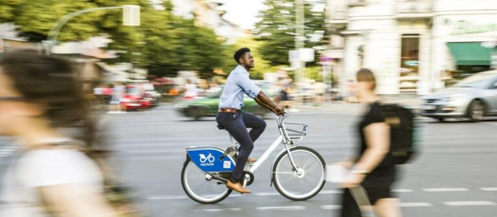 An image of a person riding their bike through a city street