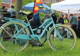A blue bicycle with Yale University's campus in the background