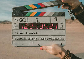 An image of a clapper board with the words "10 must-watch climate change documentaries"