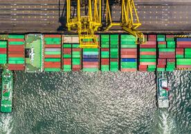 Aerial photo of a container ship being loaded by a crane