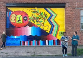 A colorful climate mural on a brick wall made using cooling paint, and sponsored by Yale Planetary Solutions