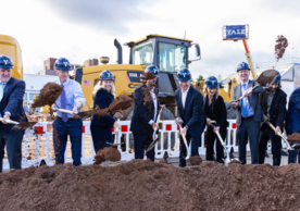 Group of Yale officials flinging shovels of dirt at a groundbreaking