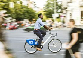 An image of a person riding their bike through a city street